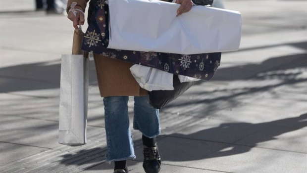 ep archivo   una persona lleva bolsas con regalos para reyes en madrid espana