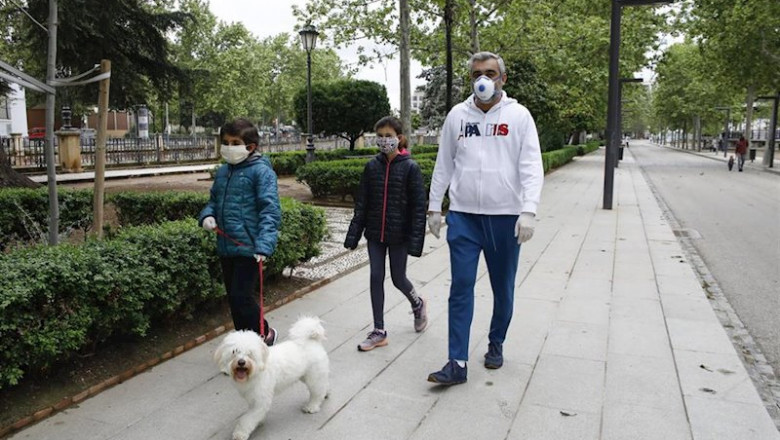 ep dos ninos con mascarillas acompanados por su padre pasean al perro el primer dia en el que los ep dos ninos con mascarillas acompanados por su padre pasean al perro el primer dia en el que los