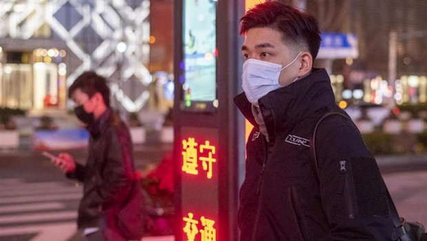 ep february 10 2020 shanghai china - two men protective masks wait at a pedestrian crossing on west