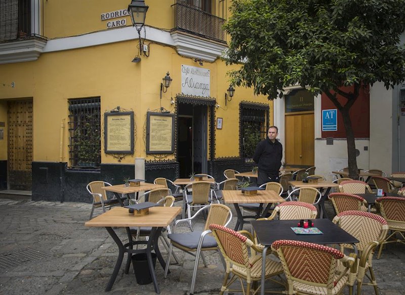 https://img4.s3wfg.com/web/img/images_uploaded/3/5/ep_un_camarero_espera_la_llegada_de_clientes_en_un_restaurante_del_barrio_de_santa_cruz_en_sevilla.jpg