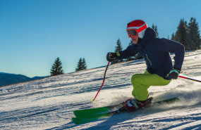 view male wearing green pants bright orange helmet while skiing sunny day 1 view male wearing green pants bright orange helmet while skiing sunny day 1
