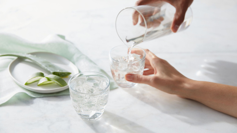 hand pouring herbal aloe concentrate original flavor into glass 