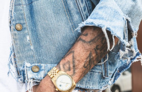 1593108101 person in round gold colored watch 2923824