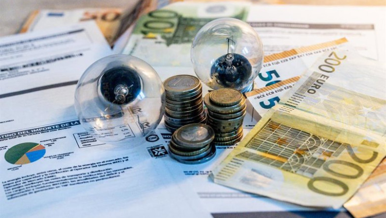 ep archivo   dos bombillas sobre billetes monedas y facturas en imagen de archivo