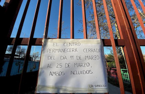 ep cartel colgado en la verja de un colegio el primer dia de cierre temporal de guarderias colegios
