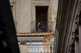 ep un joven utiliza su ordenador portatil en su terraza durante el segundo dia laborable del estado