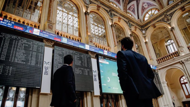 ep dos personas observan los paneles del interior del palacio de la bolsa de madrid a 24 de mayo de