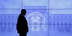 a-guard-walks-in-front-of-a-federal-reserve-image-before-press-conference-in-washington a-guard-walks-in-front-of-a-federal-reserve-image-before-press-conference-in-washington
