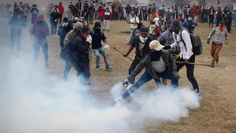 11 October 2019, Ecuador, Quito: A protestor hurls a teargas canister during clashes between Ecuadorian indigenous people and security forces. The South American country has seen nationwide protests against the government's decision to lift 40-year-old fu | Juan Diego Montenegro/dpa ep 11 october 2019 ecuador quito a protestor hurls a teargas canister during clashes between