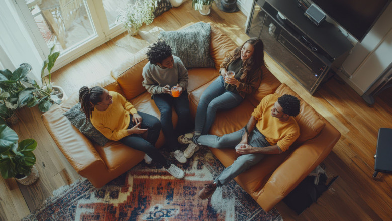 friends enjoying drinks together cozy couch modern living room filled with natural light greenery 20260918161709 