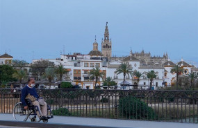 ep un ciudadano en silla de ruedas por el puente de triana casi desertico a los 40 dias de estado de