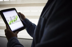 ep archivo   un hombre sujeta una tablet con un grafico a 4 de enero de 2022 en madrid espana