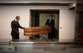 ep operarios del crematorio de girona trasladan un ataud ya desinfectado de una victima con covid-19