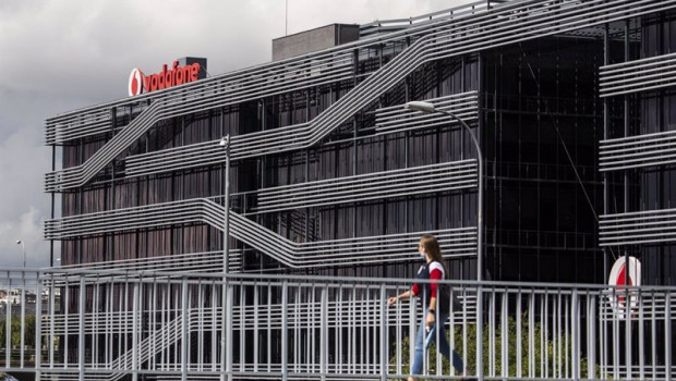 ep archivo   una persona camina al lado de la sede de vodafone en madrid el dia en el que la