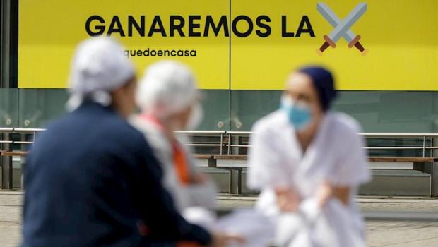 ep sanitarios junto a un cartel en el que se lee ganaremos la batalla en el hospital de campana de